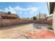 Large backyard with dirt and a small patio area at 3932 Lancome, Las Vegas, NV 89115