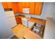 Kitchen with wood cabinets, gas stove, and double sink at 4730 E Craig Rd # 2094, Las Vegas, NV 89115