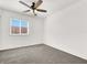 Bedroom with grey carpet, ceiling fan, and window at 5280 Plainview Ave, Las Vegas, NV 89122