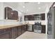 Modern kitchen with dark brown cabinets and stainless steel appliances at 5280 Plainview Ave, Las Vegas, NV 89122