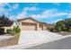 Single-story house with a two-car garage and landscaped front yard at 5840 Al Fresco Ave, Pahrump, NV 89061