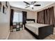 Bedroom with dark brown window curtains and a ceiling fan at 5902 Spinnaker Point Ave, Las Vegas, NV 89110