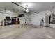 Spacious garage with overhead storage and a refrigerator at 5902 Spinnaker Point Ave, Las Vegas, NV 89110