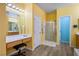 Bathroom with vanity, large mirror, and shower at 817 E La Madre Way, North Las Vegas, NV 89081