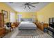 Bright bedroom with gray platform bed and ceiling fan at 817 E La Madre Way, North Las Vegas, NV 89081