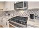 Stainless steel range and microwave in contemporary kitchen at 8452 Boseck Dr # 186, Las Vegas, NV 89145