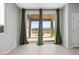 Living room with sliding glass doors and green curtains that open to a patio at 8574 Felker St, Las Vegas, NV 89166