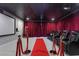 Home theater with seating, projector, and red carpet at 9637 Lions Peak Ct, Las Vegas, NV 89139