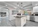 Modern kitchen featuring white cabinets, a large island, and stainless steel appliances at 9637 Lions Peak Ct, Las Vegas, NV 89139