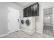 Laundry room with washer, dryer, and dark cabinets at 9637 Lions Peak Ct, Las Vegas, NV 89139