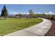 Curved concrete walkway through grassy park area at 10218 Rockridge Peak Ave, Las Vegas, NV 89166