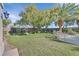 Expansive backyard with lush grass and mature trees at 10925 Iris Canyon Ln, Las Vegas, NV 89135