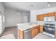 View of kitchen with wood cabinets, tile floor, and stainless steel dishwasher at 1183 Winnipeg Ct, Henderson, NV 89002