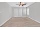 Spacious bedroom with carpeted floor, ceiling fan, and large closet at 1692 Bamboo Rain Ave, Las Vegas, NV 89183