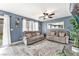 Living room with gray couches, ceiling fan, and large windows at 1975 Via Primero St, Las Vegas, NV 89115