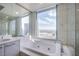 Luxurious bathroom with a large soaking tub and city views at 222 Karen Ave # 3907, Las Vegas, NV 89109