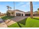 Beautiful home exterior with a three-car garage and lush landscaping at 2293 Buckingham Ct, Henderson, NV 89074