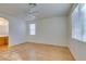 Well-lit bedroom with wood floors, window, and access to bathroom at 2379 Brockton Way, Henderson, NV 89074