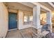 Covered entry with a dark metal security door and stone columns at 2423 Tottingham Rd, Henderson, NV 89074