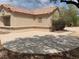 House exterior with a tile roof and a large, curved concrete patio at 2532 Big Timber Dr, Las Vegas, NV 89134