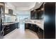 Modern kitchen with dark cabinetry, stainless steel appliances, and marble counters at 2747 Paradise Rd # 2105, Las Vegas, NV 89109