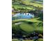 Aerial view of a golf course with a pond and palm trees at 284 Trailing Putt Way, Las Vegas, NV 89148