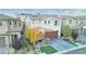 Two-story house with brown garage door and autumn colored tree in front at 3026 Coveri Ct, Las Vegas, NV 89141