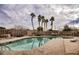 Community pool with palm trees and lounge chairs at 4608 Snake Eyes St # 102, Las Vegas, NV 89122