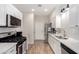 White kitchen boasts stainless steel appliances and quartz countertops at 500 Sutters Mill Rd, Henderson, NV 89014