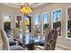 Elegant dining room with lake views, glass table, and comfortable seating at 6 Via Mira Monte, Henderson, NV 89011