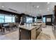 Open concept kitchen with granite island, breakfast bar, and stainless steel appliances at 6481 Farness St, Las Vegas, NV 89135