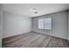 Simple bedroom with wood-look flooring and a window with blinds at 6754 Broadacres Ranch St, Las Vegas, NV 89148