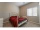 Cozy bedroom with white metal bed frame and red bedding at 6837 Dragonfly Rock St, Las Vegas, NV 89148