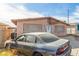 Exterior view of the house with a car parked in the driveway at 887 W Carey Ave, North Las Vegas, NV 89030