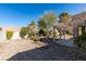 Desert landscaping with covered patio and mature trees at 8916 Desert Mound Dr, Las Vegas, NV 89134