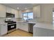 Modern kitchen with white shaker cabinets and quartz countertops at 8916 Desert Mound Dr, Las Vegas, NV 89134