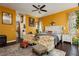 Large main bedroom with mustard yellow walls and comfortable seating at 9990 Four Views St, Las Vegas, NV 89143