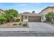 Single-story home with two-car garage and well-manicured landscaping at 10369 Niagara Falls Ln, Las Vegas, NV 89144