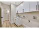 Clean laundry room features ample cabinetry and vinyl flooring at 10369 Niagara Falls Ln, Las Vegas, NV 89144