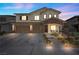 Two-story house with tan siding, brown garage doors, and landscaping at 232 Punto Di Vista Dr, Henderson, NV 89011