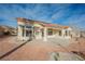 Home's back exterior with covered patio and solar panels at 2652 Youngdale Dr, Las Vegas, NV 89134