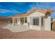 Home's back exterior with a large patio, bay window, and solar panels at 2652 Youngdale Dr, Las Vegas, NV 89134