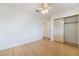 Well-lit bedroom with mirrored closet doors and ceiling fan at 411 Opal Dr, Henderson, NV 89015