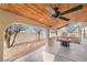 Covered patio with ceiling fan, pool table, and backyard access at 411 Opal Dr, Henderson, NV 89015