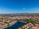 Aerial view of lakefront community and city skyline at 7809 Cocoa Beach Cir, Las Vegas, NV 89128