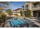 Luxury pool and spa with stonework and lounge chairs at 2215 Alcova Ridge Dr, Las Vegas, NV 89135