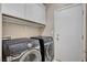 Laundry room with Samsung washer and dryer, and overhead cabinets at 319 Fox Lake Ave, Las Vegas, NV 89148