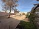 Large backyard with mature tree and sand at 4143 Laurel Park Ave, Las Vegas, NV 89103