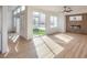 Bright living room with wood-look floors, fireplace, and sliding glass doors to backyard at 4623 Harvest Night St, Las Vegas, NV 89129