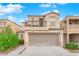 Two-story house with balcony, attached garage, and landscaping at 7338 Umberto St, Las Vegas, NV 89148